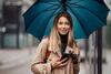 woman walking in the rain holding an umbrella